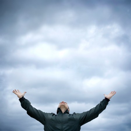 A man embracing the coming rain