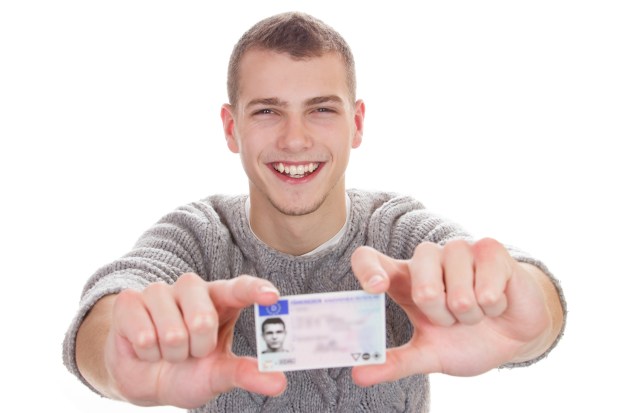 Young man showing his driver license